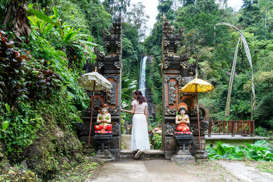 Woman at the entrance of Gitgit waterfall in Bali , Singaraja, Indonesia