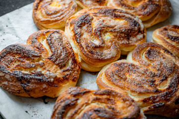 Freshly baked golden buns close-up. Homemade pastry with crispy crust and soft texture, delicious bakery concept.