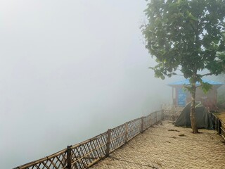 hills with beautiful clouds in the morning. Summer Mountain with green plants and clouds in the sky. wooden hut on Mountain. Texture of green tree forest view from above, Beautiful sunrise.