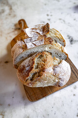 Bread, traditional sourdough, homemade sourdough bread cut into slices on a rustic wooden cutting...