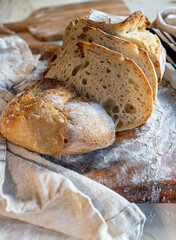 Bread, traditional sourdough, homemade sourdough bread cut into slices on a rustic wooden cutting...