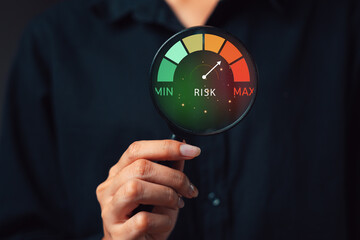 Investor Risk Management and Assessment Concept. A business or investor holding magnifying glass...