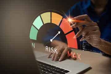 Business risk management concept with risk level indicator on virtual screen. A professional hand...
