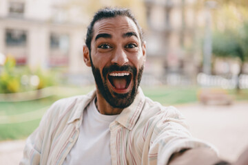 Excited man opens mouth in surprise during selfie, showing bold emotion and connection through...