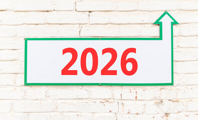 Obraz premium Business concept of 2026 new year symbol. Concept number 2026 Happy new year on beautiful white road sign. Beautiful old white brick wall background. Business 2026 happy new year concept. Copy space.