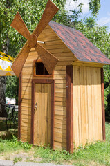 A wooden mill. View of the mill on the side.