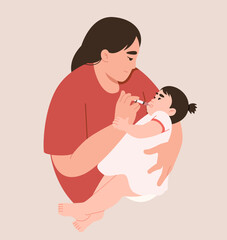 Mother gives medicine to daughter through syringe