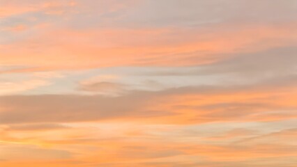Serene Pastel Sunset Sky with Gentle Orange and Pink Clouds Creating a Tranquil Evening Horizon Landscape