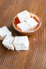 Assorted Turkish Delights in a Copper Bowl on a Wooden Table (Close-Up)
