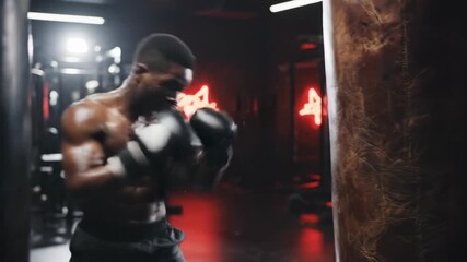 Muscular boxer training in a dark gym punching a heavy bag. Intense workout of a professional athlete. Strength and determination concept - Powered by Adobe