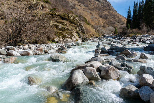 Ala-Archa Park, Fast flowing alpine stream with boulders and rapids, nestled in remote wilderness. Hiking, backcountry exploration, outdoor adventure, nature lovers, and challenging mountain journeys