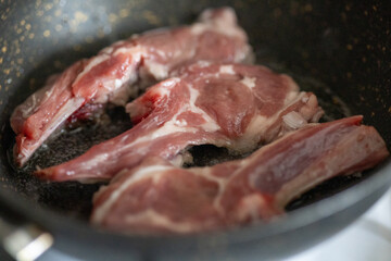 Raw Chops with Garlic and Spices on a Wooden Plate
