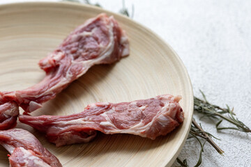 Raw Chops with Garlic and Spices on a Wooden Plate
