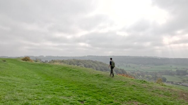 Hiker on the hill in Cotswolds, near Dursley and Uley. Autumn Travel in United Kingdom