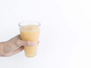Hand serving fresh starfruit juice on white. Healthy yellow carambola drink with copy space, tropical smoothie concept for summer ads, menu, or healthy lifestyle design.
