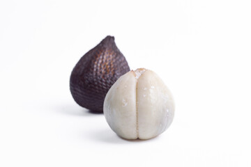Whole and peeled salak or snake fruit isolated on white background. Exotic Indonesian tropical fruit for healthy diet, organic food, or Asian cuisine concept.
