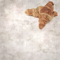 square stylish old textured paper background with croissant