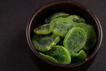 Dried kiwi fruit slices in a ceramic bowl