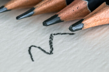 Colored and black pencils, on a notebook, drawing related to art and school.