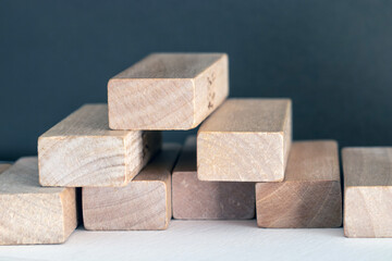 Wooden prisms, forming geometric forms. Close-up background.