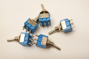 Small electric switches. Electric toggle switch. Blue switches.