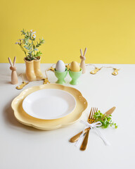 Happy Easter. Easter celebration concept. Top view vertical empty white and yellow plate, Easter eggs, on isolated white background. Copy space, place for text, banner.