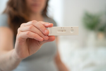 Anxious expecting mother examining PCR test outcome at home. Modern diagnostic method for detecting infections during pregnancy.