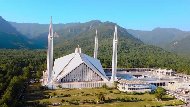 Grand Aerial View of Faisal Mosque and its Minarets against the Lush Margalla Hills