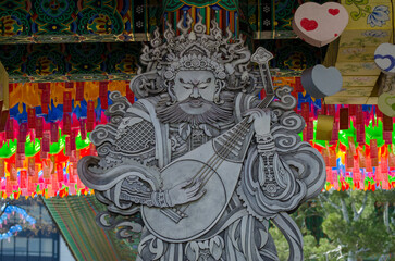 Guardian statue and lanterns at Jogyesa Temple, Seoul