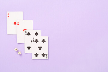 Poker chips and playing cards on color background, top view. Casino card game