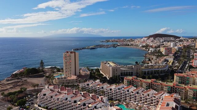 Aerial view of Los Cristianos, southeast coast in Tenerife island. Drone POV from mountain Guaza located in Canary Island of Spain.