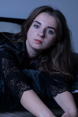 Fototapeta premium Woman wearing black lace robe relaxing on bed