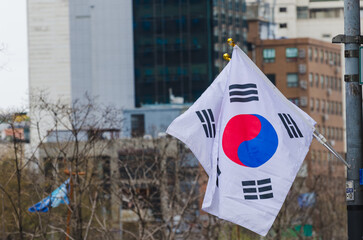 South Korean flag waving in city, symbolizing pride and identity