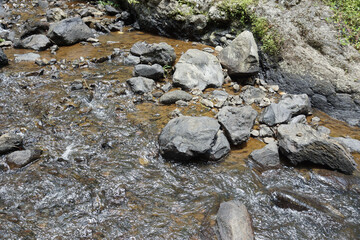 The natural rocks that are visible on the surface and inside the waterfall river are clear so that it can be seen all the way to the bottom of the river
