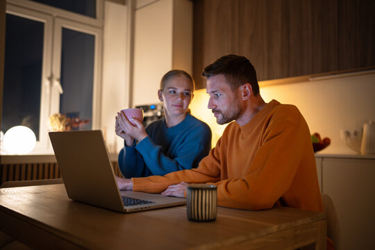 Peaceful husband and wife browsing internet and selecting movie for night with drink. Family evening routine, relaxed work from home, web feed and social media search, online selection, freelance work