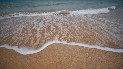 Soft wave gently washing sandy beach in Crimea