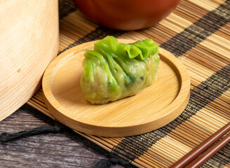 vibrant green dumpling on a rustic wood plate! Perfect for menus and blogs, it captures authentic...