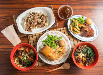 A delicious Taiwanese meal featuring braised pork rice, chicken leg, pork chop and beef noodles. Perfect for showcasing authentic cuisine or menu designs