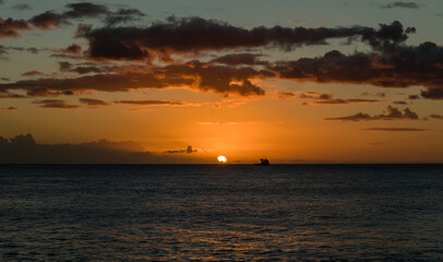 Beautiful west Oahu sunset with a ship silhouette at the horizon, Hawaii