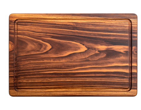Overhead shot of a rectangular wooden cutting board with a recessed juice groove