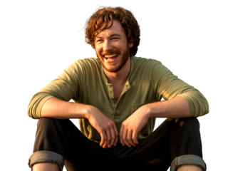 Relaxed young man sitting casually and smiling outdoors warm lifestyle portrait