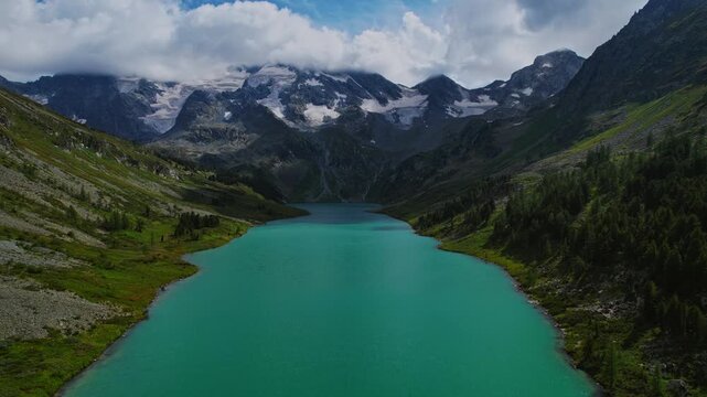 Aerial Summer beautiful Landscape Altai with high mountain lake with clear blue water from glaciers Poperechnoye Multinskoye.