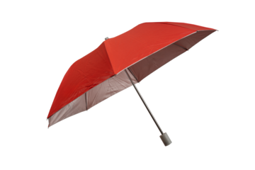 Bright red compact folding umbrella partially opened, featuring a silver metal shaft and a gray plastic tip, isolated on a white background. Isolated.