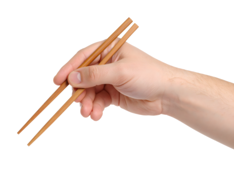 Graceful hand holding wooden chopsticks ready to enjoy delicious Asian cuisine with precision