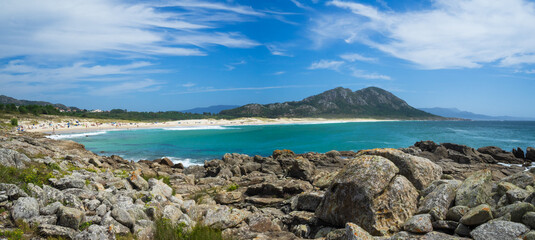 Ancoradoiro beach turquoise waters in front of Mount Louro, Galicia
