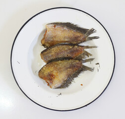 Fried gourami on a plate