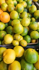Different Varieties of Stemmed Natural Tangerines on Grocery Store Shelves
