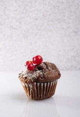 Bright and clean Chocolate Muffin with Red Currants on white Background