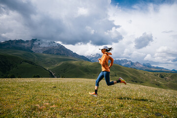 Female runner running on the high altitude grassland mountain top