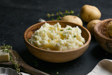 Mushed potatoes top view with raw potatoes and spices